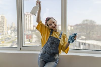 Beautiful smiling young woman cleaning.jpg