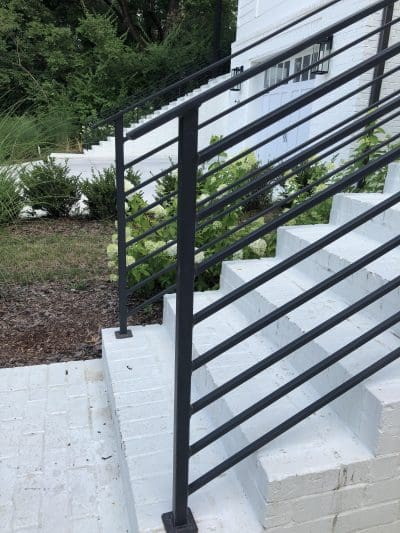 black powder coated stair railing new construction Green Hills mounted on brick.JPG
