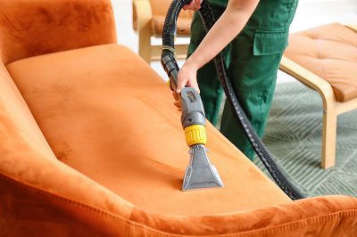 dry-cleaner-s-employee-removing-dirt-from-sofa-house.jpg